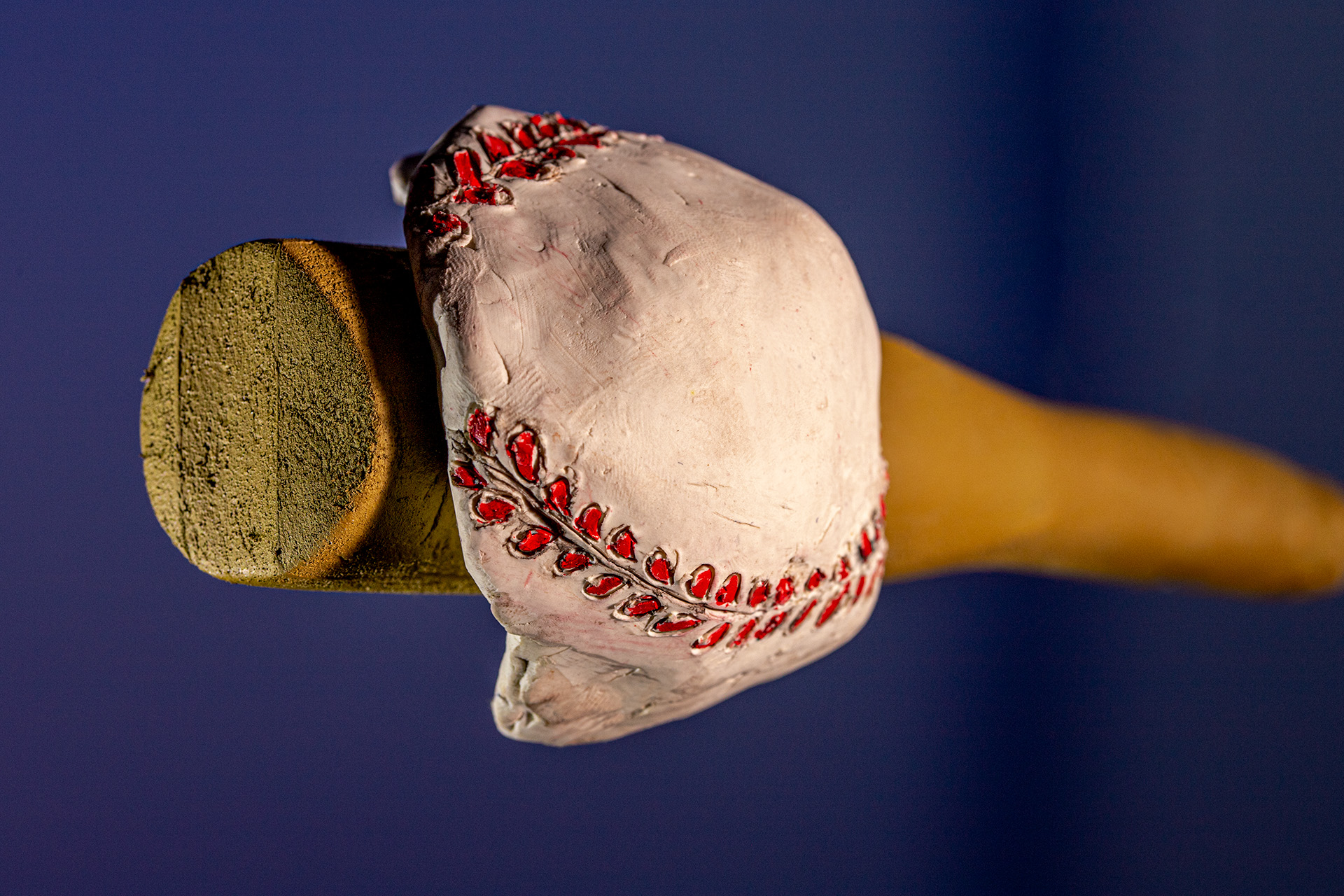 A baseball being deformed by a baseball bat
