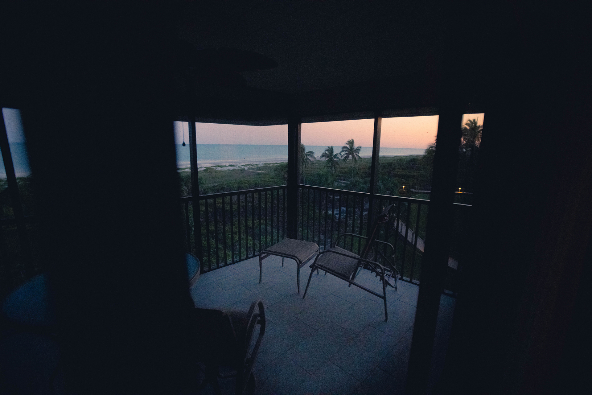 A porch facing the ocean during a sunset